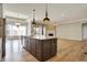 Open kitchen featuring a central island that overlooks the living room and dining area at 16544 Gaither Ct, Westfield, IN 46074