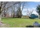 Spacious backyard featuring a large shed, mature trees, and lush lawn, perfect for outdoor activities at 1667 Decourcy Ct, Franklin, IN 46131