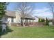 Beautifully landscaped backyard with a well-maintained lawn, mature trees, and a charming wooden deck at 1667 Decourcy Ct, Franklin, IN 46131