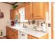 Functional kitchen with white appliances, wood cabinets, and efficient layout for cooking and storage at 1667 Decourcy Ct, Franklin, IN 46131