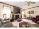 Cozy living room features a brick fireplace, large windows, and comfortable seating arrangements at 1667 Decourcy Ct, Franklin, IN 46131