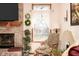 Close up of brick fireplace in living room, decorative accents, and natural light streaming through window at 1667 Decourcy Ct, Franklin, IN 46131