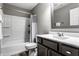 Bathroom with a shower/tub combo, dark vanity, and white sink at 17099 Cole Evans Dr, Noblesville, IN 46060