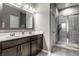 Modern bathroom featuring double vanity, framed mirror, and glass-enclosed shower at 17099 Cole Evans Dr, Noblesville, IN 46060