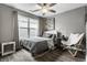 Cozy bedroom with a patterned quilt, a gray headboard, and natural light from the window at 17099 Cole Evans Dr, Noblesville, IN 46060