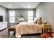 Stylish bedroom with two windows, a decorative mirror, and a comfortable bed at 17099 Cole Evans Dr, Noblesville, IN 46060
