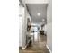 Hallway with hardwood floors leading to the kitchen and living spaces at 17099 Cole Evans Dr, Noblesville, IN 46060