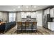 Eat-in kitchen featuring stainless steel appliances, sleek white cabinets, and a kitchen island with seating at 17099 Cole Evans Dr, Noblesville, IN 46060