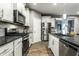 Modern kitchen featuring stainless steel appliances, sleek white cabinets, and granite countertops at 17099 Cole Evans Dr, Noblesville, IN 46060