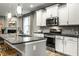 Modern kitchen featuring stainless steel appliances, sleek white cabinets and a kitchen island with seating at 17099 Cole Evans Dr, Noblesville, IN 46060