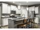 Modern kitchen features stainless steel appliances, sleek white cabinets and a large kitchen island at 17099 Cole Evans Dr, Noblesville, IN 46060