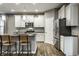 Modern kitchen featuring stainless steel appliances, sleek white cabinets and a kitchen island with seating at 17099 Cole Evans Dr, Noblesville, IN 46060