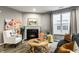 Comfortable living room with fireplace, stylish furniture, and a bright, cozy atmosphere at 17099 Cole Evans Dr, Noblesville, IN 46060