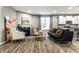 Open-concept living room with hardwood floors and seamless flow into the modern kitchen at 17099 Cole Evans Dr, Noblesville, IN 46060