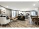 Open-concept living room with hardwood floors and seamless flow into the modern kitchen at 17099 Cole Evans Dr, Noblesville, IN 46060