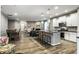 Open-concept layout with kitchen, living, and dining areas featuring hardwood floors and plenty of natural light at 17099 Cole Evans Dr, Noblesville, IN 46060