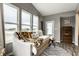 Sunlit sitting area features large windows with scenic views, and cozy decor at 17099 Cole Evans Dr, Noblesville, IN 46060