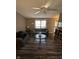 Cozy living room with large window, ceiling fan, hardwood floors, and comfortable seating at , Indianapolis, IN 46219