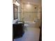 Elegant bathroom featuring a vanity with decorative mirror and a tiled shower and bath at 189 S Jefferson St, Martinsville, IN 46151