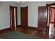 Bedroom with hardwood floors, gray walls, and three open doorways to other rooms at 189 S Jefferson St, Martinsville, IN 46151