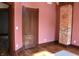 Bedroom featuring hardwood floors, exposed brick, and stylish trim at 189 S Jefferson St, Martinsville, IN 46151