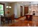 View of dining room leading into kitchen area with pendant lights, light walls, and hardwood floors at 189 S Jefferson St, Martinsville, IN 46151