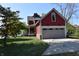 Red home featuring an attached two-car garage with a lovely lawn at 189 S Jefferson St, Martinsville, IN 46151