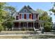 Charming two-story red home with a classic wrap-around porch at 189 S Jefferson St, Martinsville, IN 46151