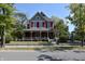 Charming two-story red house with a large front porch and well-maintained landscaping at 189 S Jefferson St, Martinsville, IN 46151