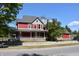 Attractive two-story red home featuring a gray roof and a lovely front porch at 189 S Jefferson St, Martinsville, IN 46151