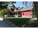 Charming red home featuring a welcoming front porch and well-maintained lawn at 189 S Jefferson St, Martinsville, IN 46151