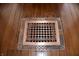 Close up of decorative copper floor vent on hardwood floors at 189 S Jefferson St, Martinsville, IN 46151