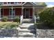 Inviting front entrance with a stone staircase leading to a classic red home, enhanced by a well-manicured lawn at 189 S Jefferson St, Martinsville, IN 46151