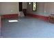 An empty garage with light gray epoxy floors, gray walls with red trim, and natural light at 189 S Jefferson St, Martinsville, IN 46151