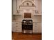 Close up of a kitchen featuring a stainless steel stove, stone countertops, and custom white cabinets at 189 S Jefferson St, Martinsville, IN 46151