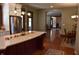 Open kitchen featuring white cabinets, granite countertops, stainless steel appliances, kitchen island and hardwood floors at 189 S Jefferson St, Martinsville, IN 46151