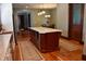 Kitchen with center red island featuring stainless steel appliances, granite countertops, and light hardwood flooring at 189 S Jefferson St, Martinsville, IN 46151