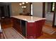 Close up of kitchen island featuring granite countertop, stainless steel appliances and red custom cabinets at 189 S Jefferson St, Martinsville, IN 46151