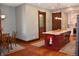 Kitchen island with white countertops, custom cabinets, and views to a laundry room, with hardwood floors at 189 S Jefferson St, Martinsville, IN 46151