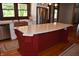 Spacious kitchen with center island featuring granite countertop, stainless steel appliances and red custom cabinets at 189 S Jefferson St, Martinsville, IN 46151
