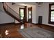 Inviting living room with hardwood floors, decorative staircase, and bright natural light at 189 S Jefferson St, Martinsville, IN 46151