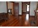 Spacious living area featuring hardwood floors, brick fireplace, and classic trim at 189 S Jefferson St, Martinsville, IN 46151
