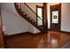 Living room boasts gorgeous hardwood floors and decorative trim around door and staircase at 189 S Jefferson St, Martinsville, IN 46151