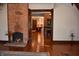 Elegant living room featuring exposed brick fireplace and hardwood floors, creating a warm and inviting atmosphere at 189 S Jefferson St, Martinsville, IN 46151