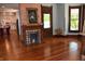 Living room showcases hardwood floors, decorative fireplace and view to kitchen area at 189 S Jefferson St, Martinsville, IN 46151