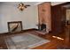 Bright living room features hardwood floors, brick fireplace, and ornate light fixture at 189 S Jefferson St, Martinsville, IN 46151