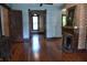 Hardwood floors and a brick fireplace accentuate an open living room design at 189 S Jefferson St, Martinsville, IN 46151