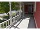 Home featuring a spacious front porch with white pillars and decorative railing at 189 S Jefferson St, Martinsville, IN 46151