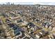 Expansive aerial view of a neighborhood featuring a mix of colorful houses near a bustling cityscape at 2031 Central Ave, Indianapolis, IN 46202