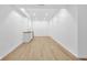 Spacious basement with wood-look vinyl plank flooring, kitchenette, and white trim at 2031 Central Ave, Indianapolis, IN 46202